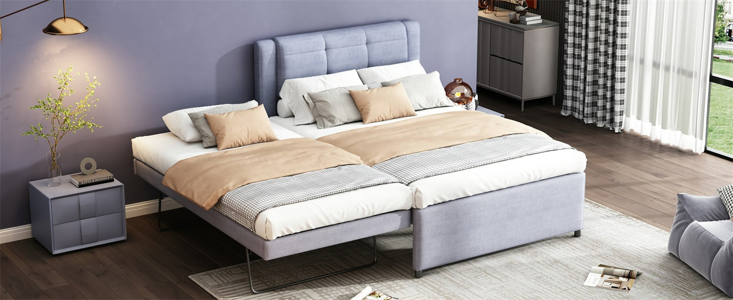 Light blue upholstered twin beds with tan and grey bedding arranged sidebyside