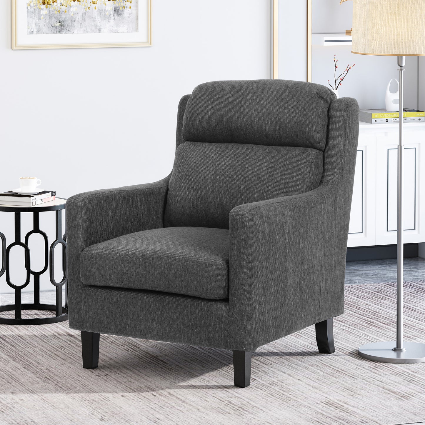 Upholstered accent chair in charcoal grey fabric with high back and padded arms