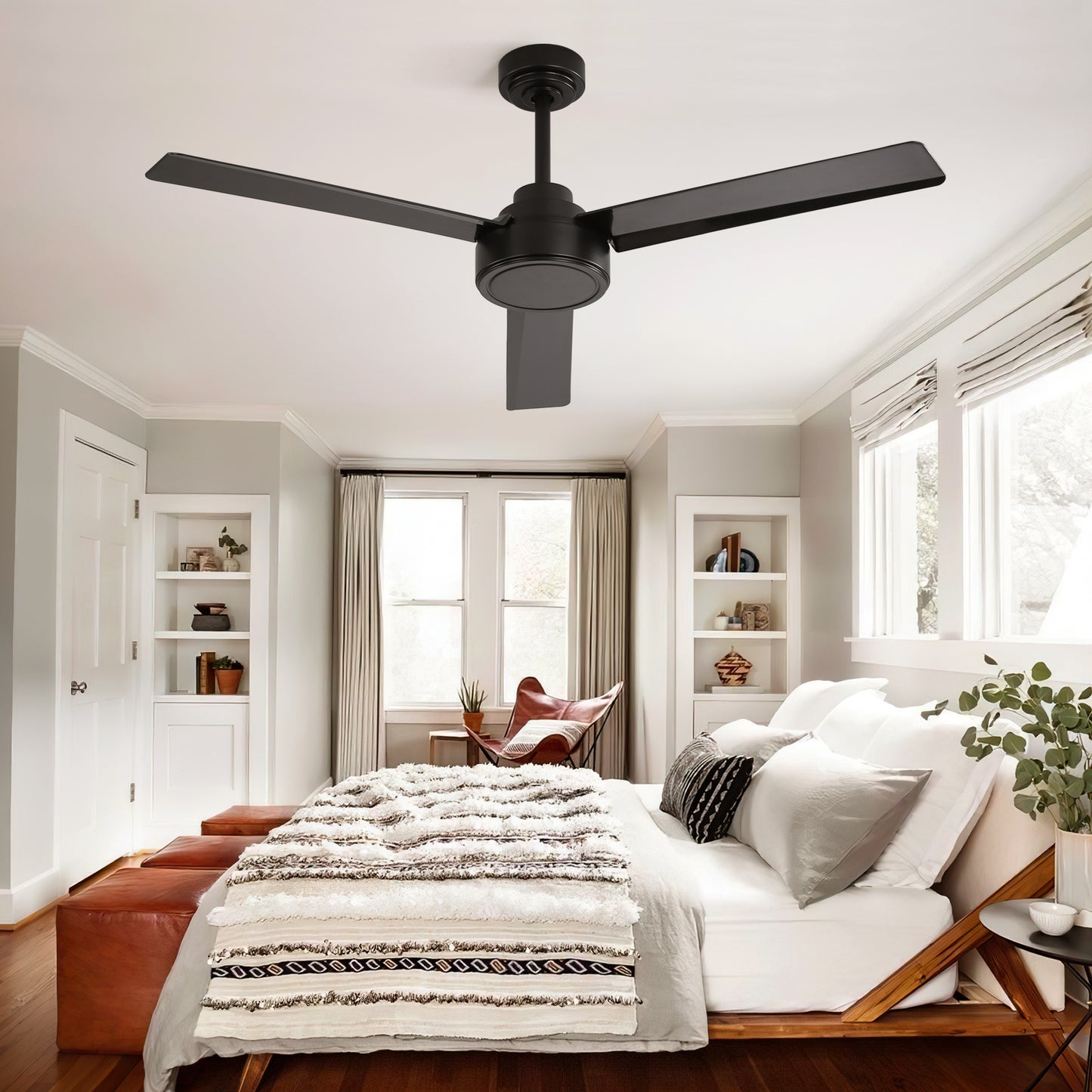 Black threeblade modern ceiling fan above a bed