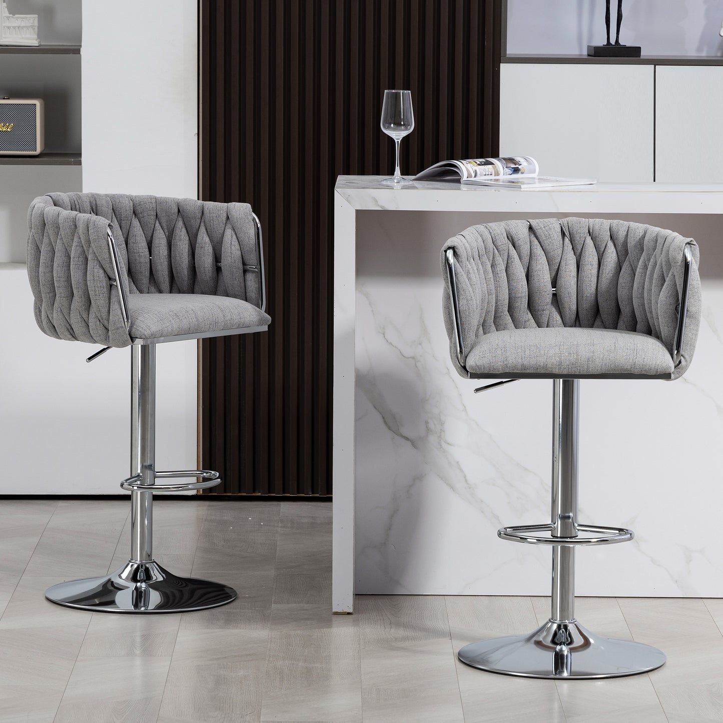 Two gray upholstered swivel bar stools with chrome bases and adjustable height