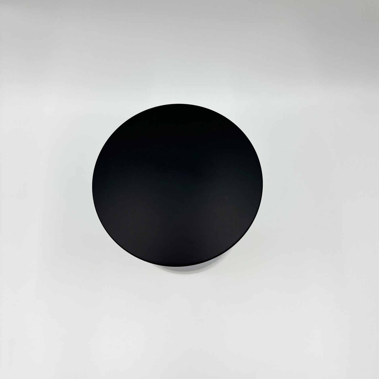 Black round metal lid for a container