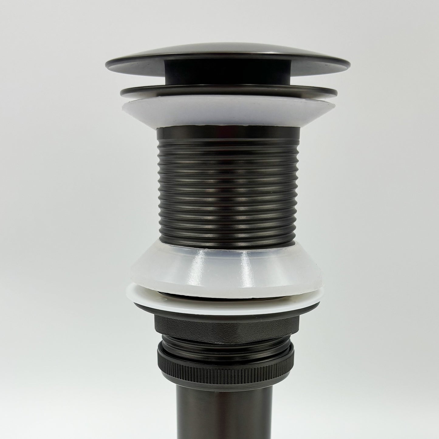 Oil rubbed bronze popup drain assembly with white gaskets for sink installation