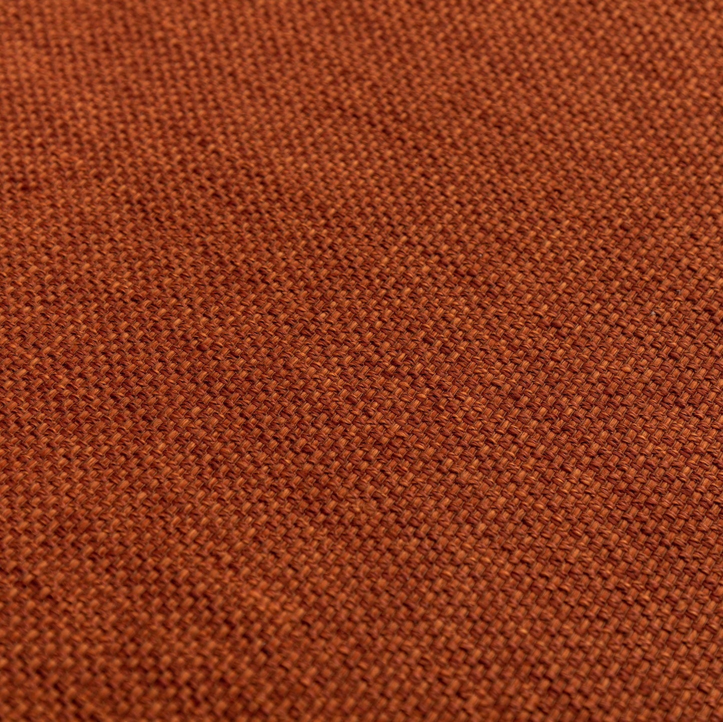 Closeup of textured burnt orange linen fabric weave ideal for upholstery
