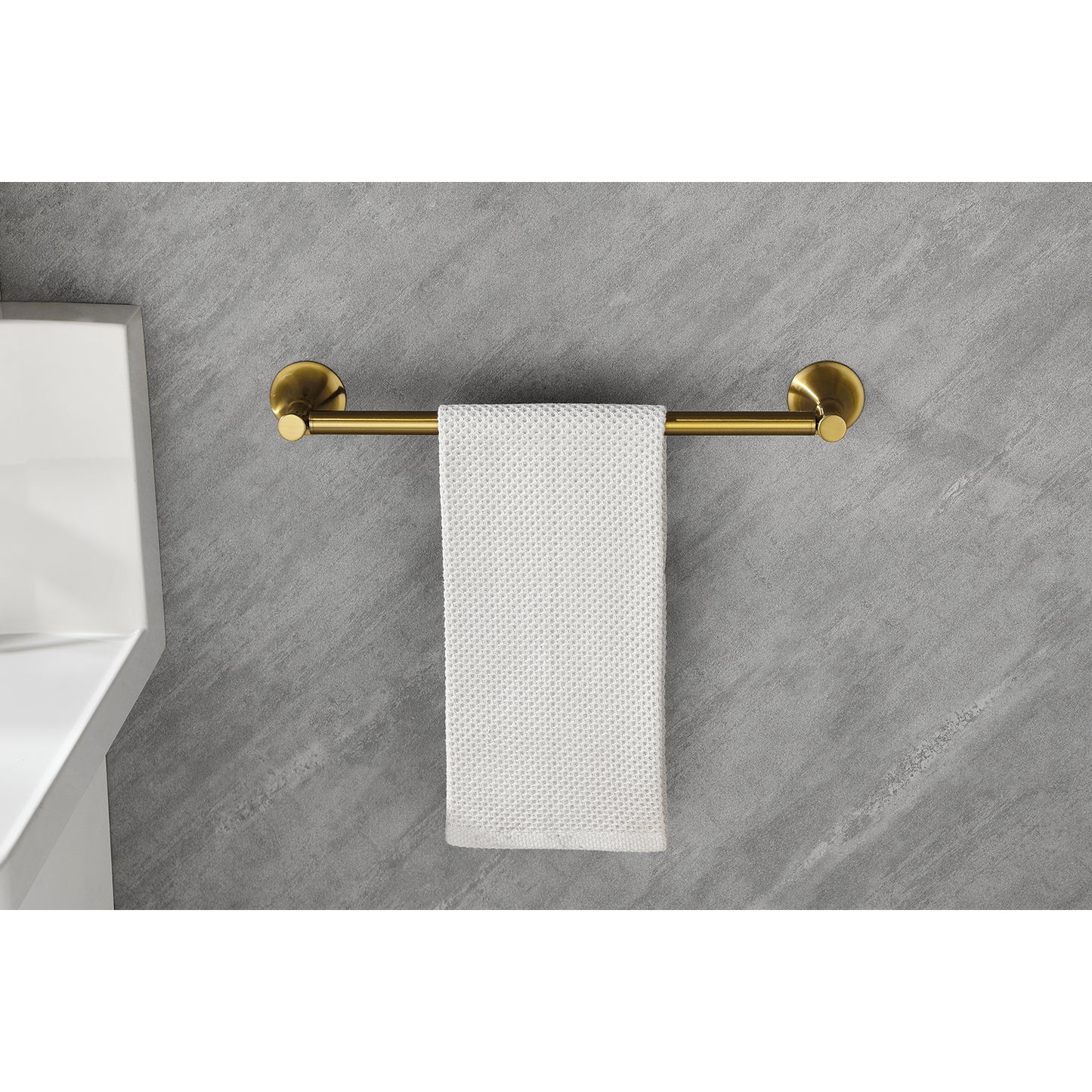 Brushed brass towel bar with a modern design holding a white textured hand towel
