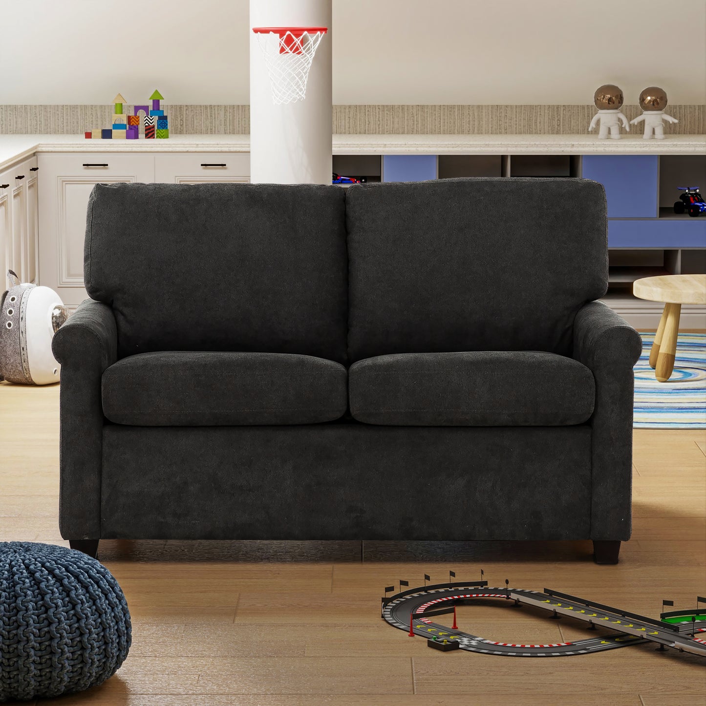 Dark gray upholstered loveseat with plush cushions perfect for compact living spaces