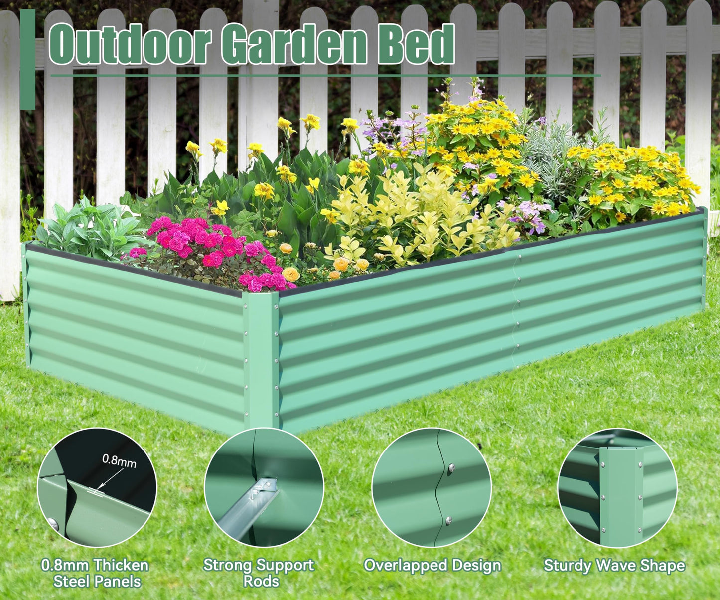 Green corrugated metal raised garden bed with flowers and white picket fence