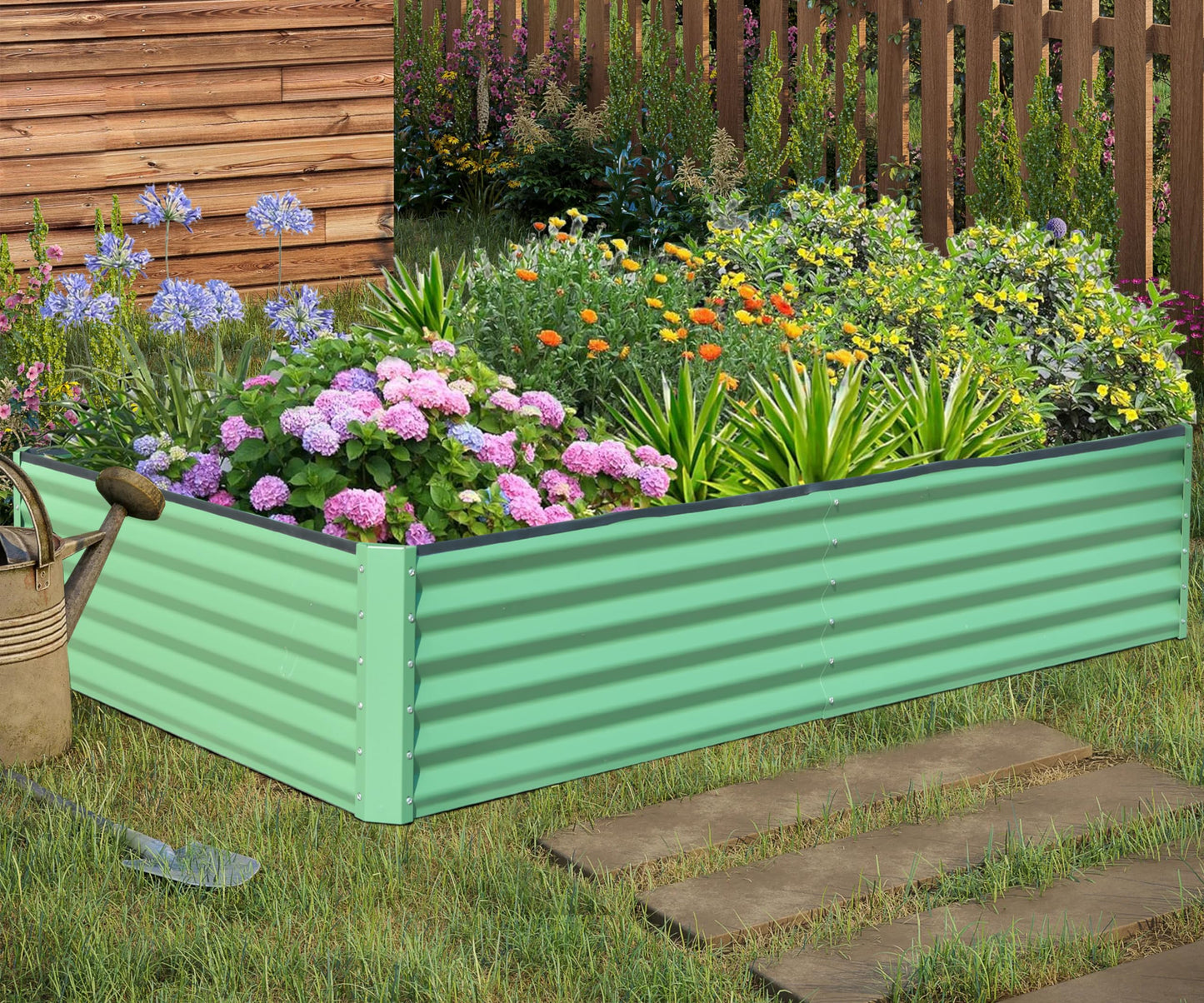 Light green corrugated metal raised garden bed overflowing with colorful flowers