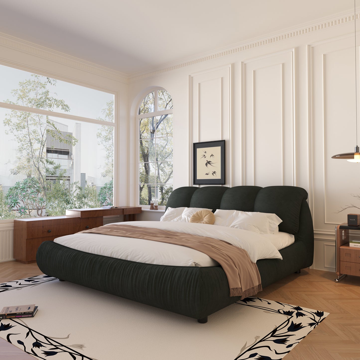 Dark green pleated fabric bed with white linens and a tan throw