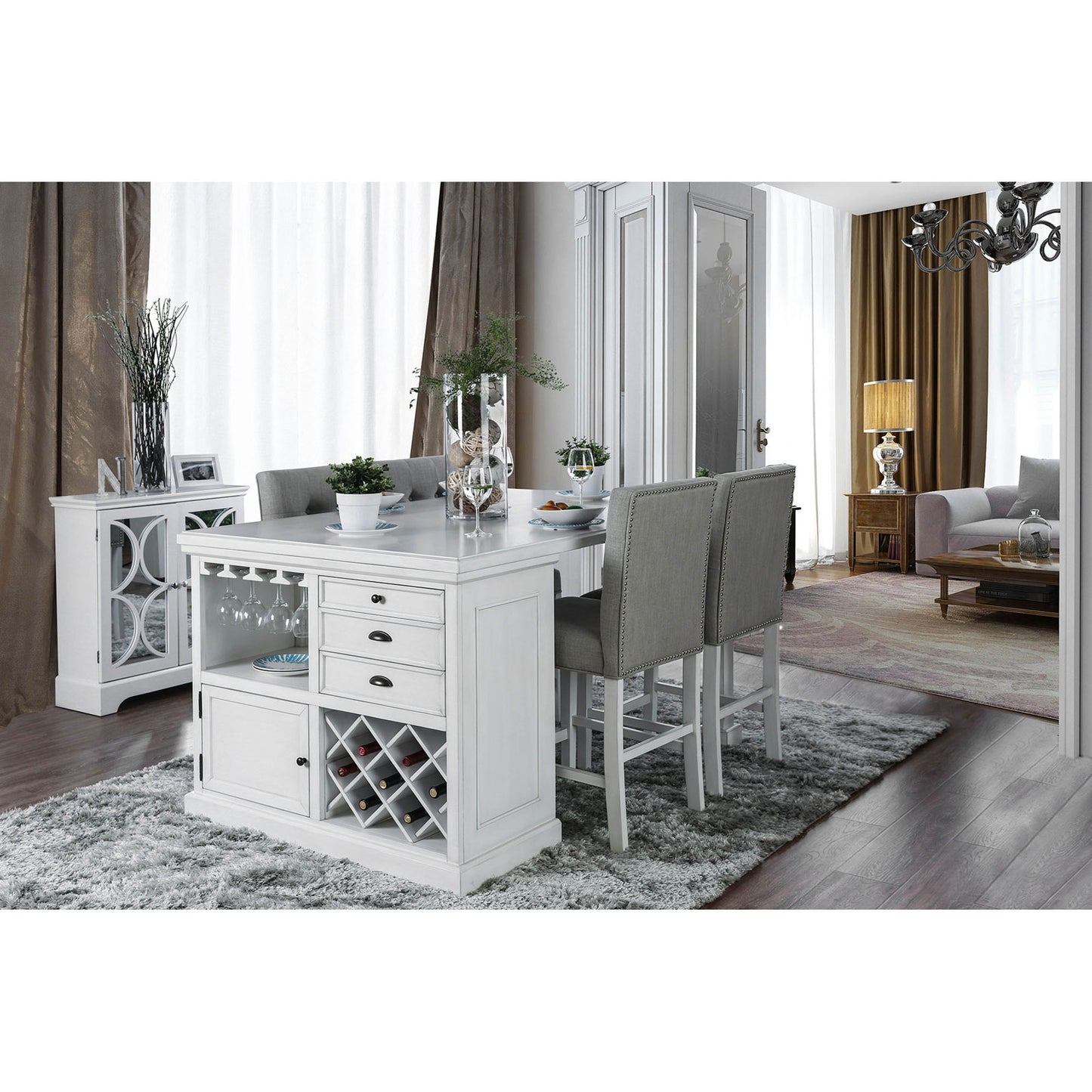 White kitchen island with wine rack and grey upholstered stools