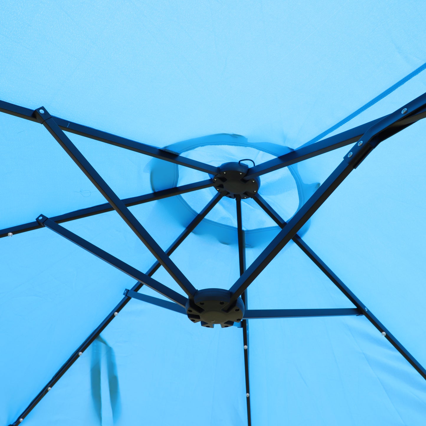 Underside view of a sky blue canopy tent frame and fabric