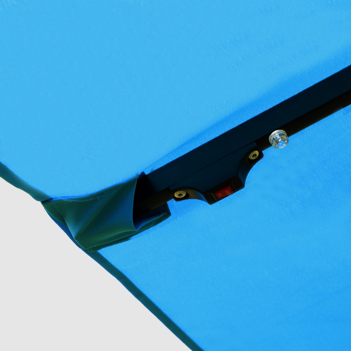 Closeup of a blue canopy with an integrated light switch for outdoor lighting