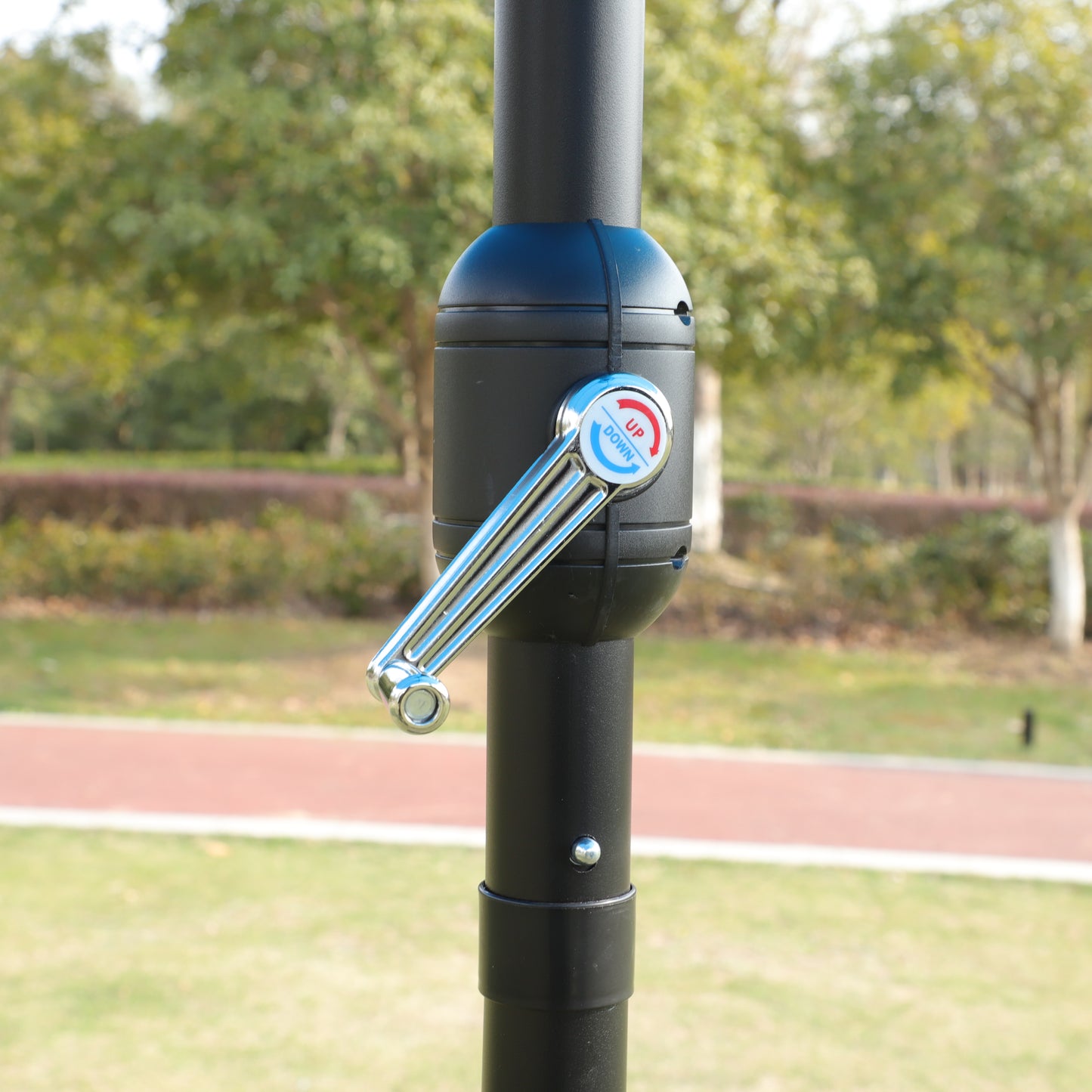 Black patio umbrella crank with UPDOWN indicator for easy operation