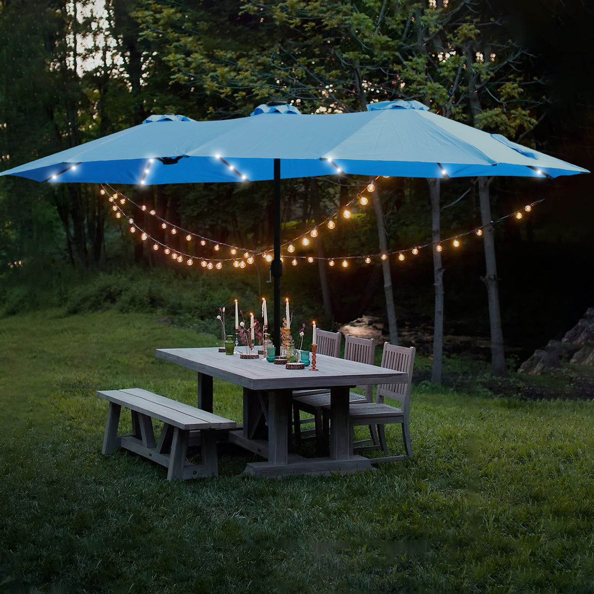 Blue patio umbrella with integrated LED lights over a wooden dining set