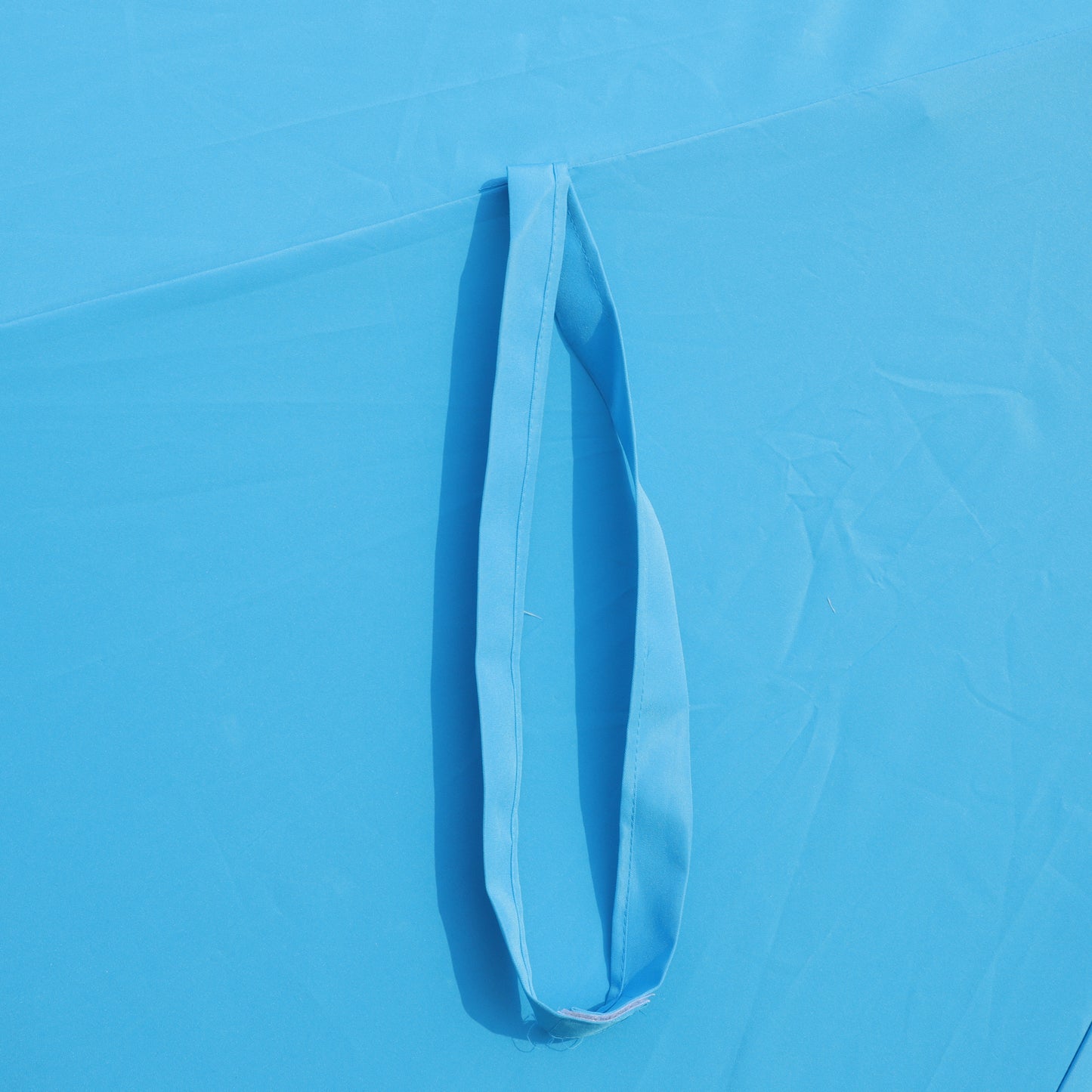 Blue fabric tote bag with reinforced stitching on strap