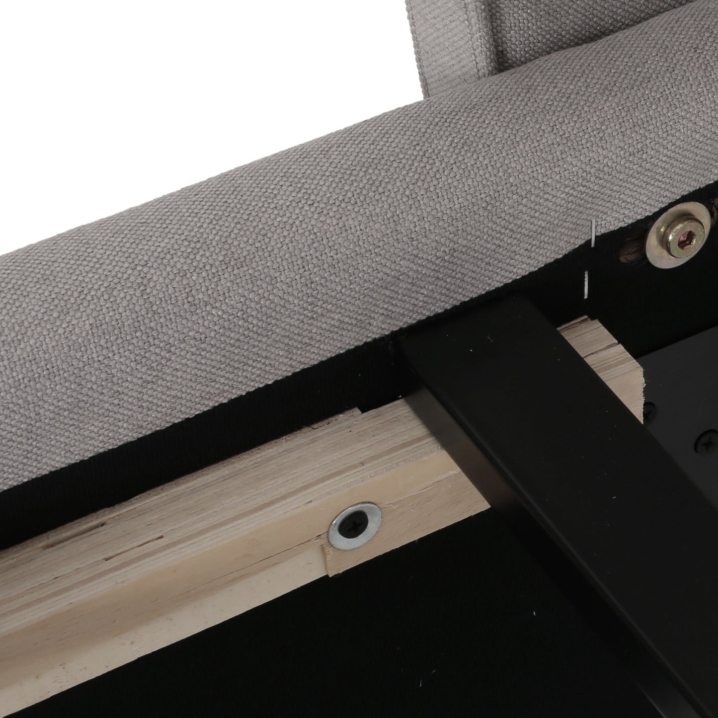 Close up of gray upholstered furniture frame with visible wooden supports and metal hardware