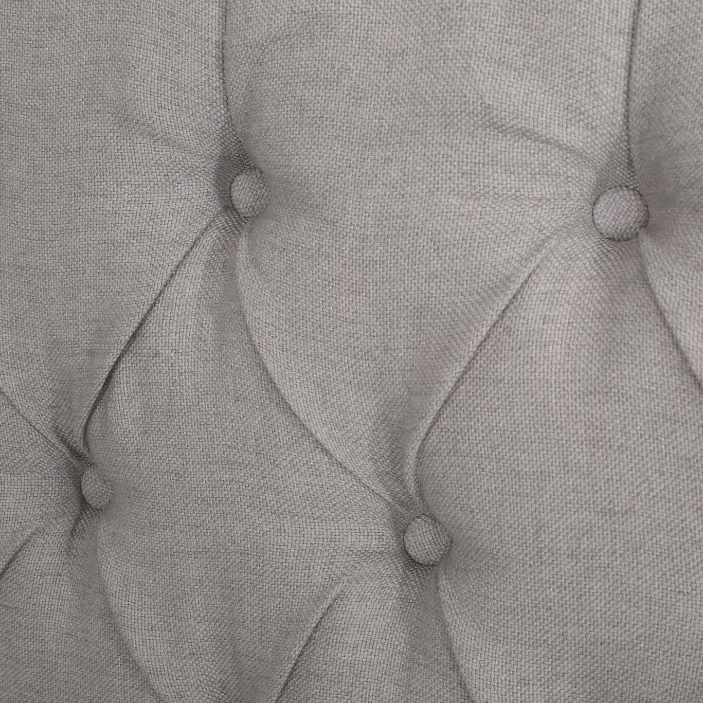 Closeup of grey linen tufted upholstery fabric detail with visible weave