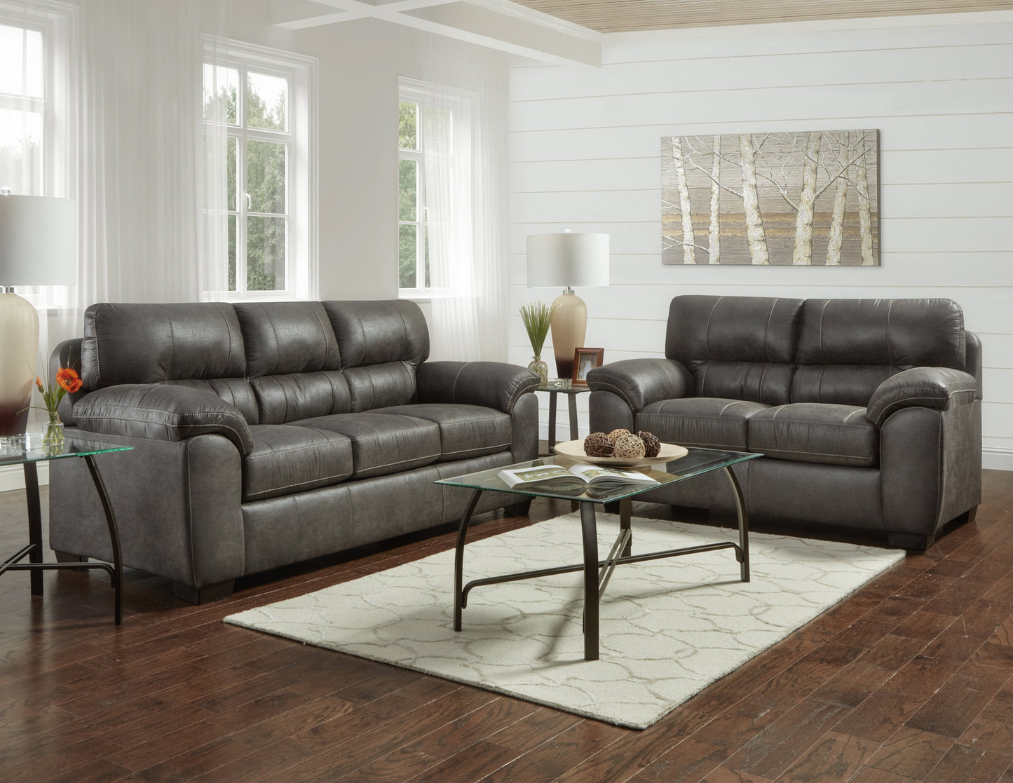Dark charcoal faux leather sofa with contrast stitching a classic living room centerpiece