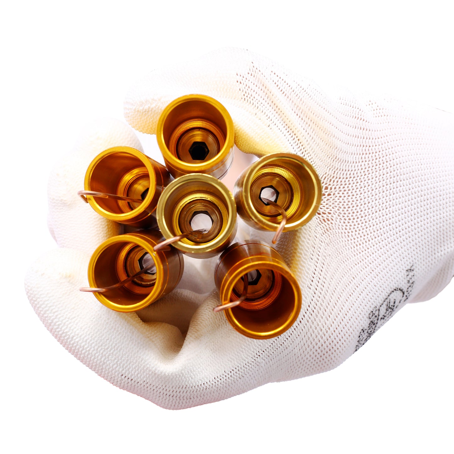Five goldplated copper contacts with internal hexagonal sockets held in a gloved hand