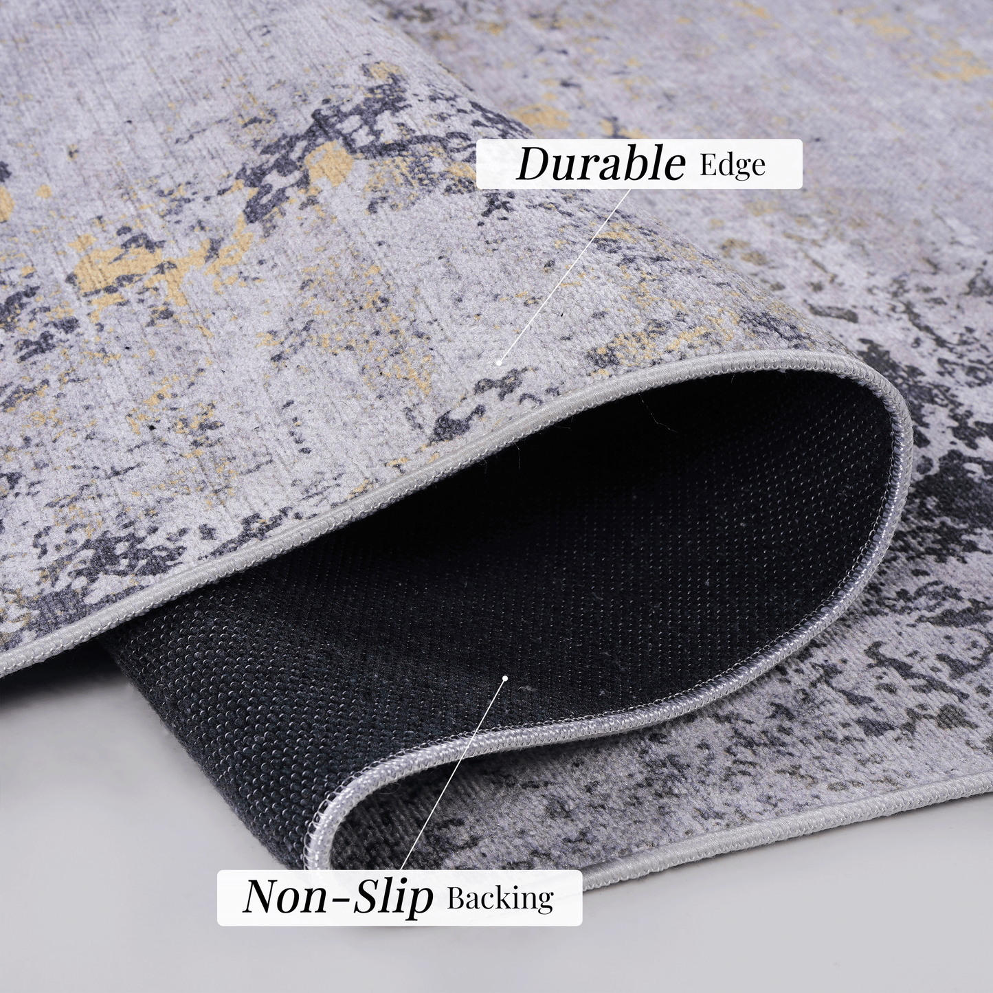 Closeup of a grey and gold abstract pattern modern rug with a nonslip backing and durable edge