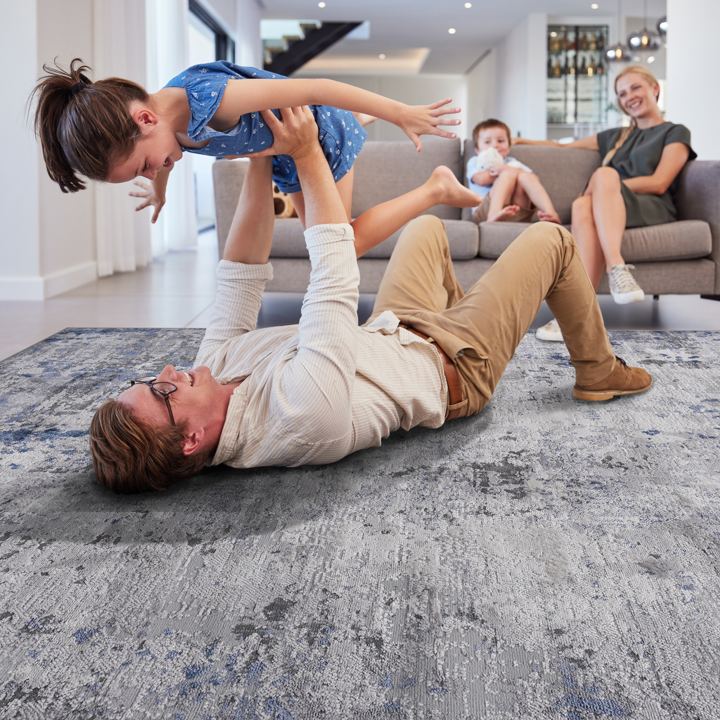 Abstract blue and grey distressed area rug with textured details