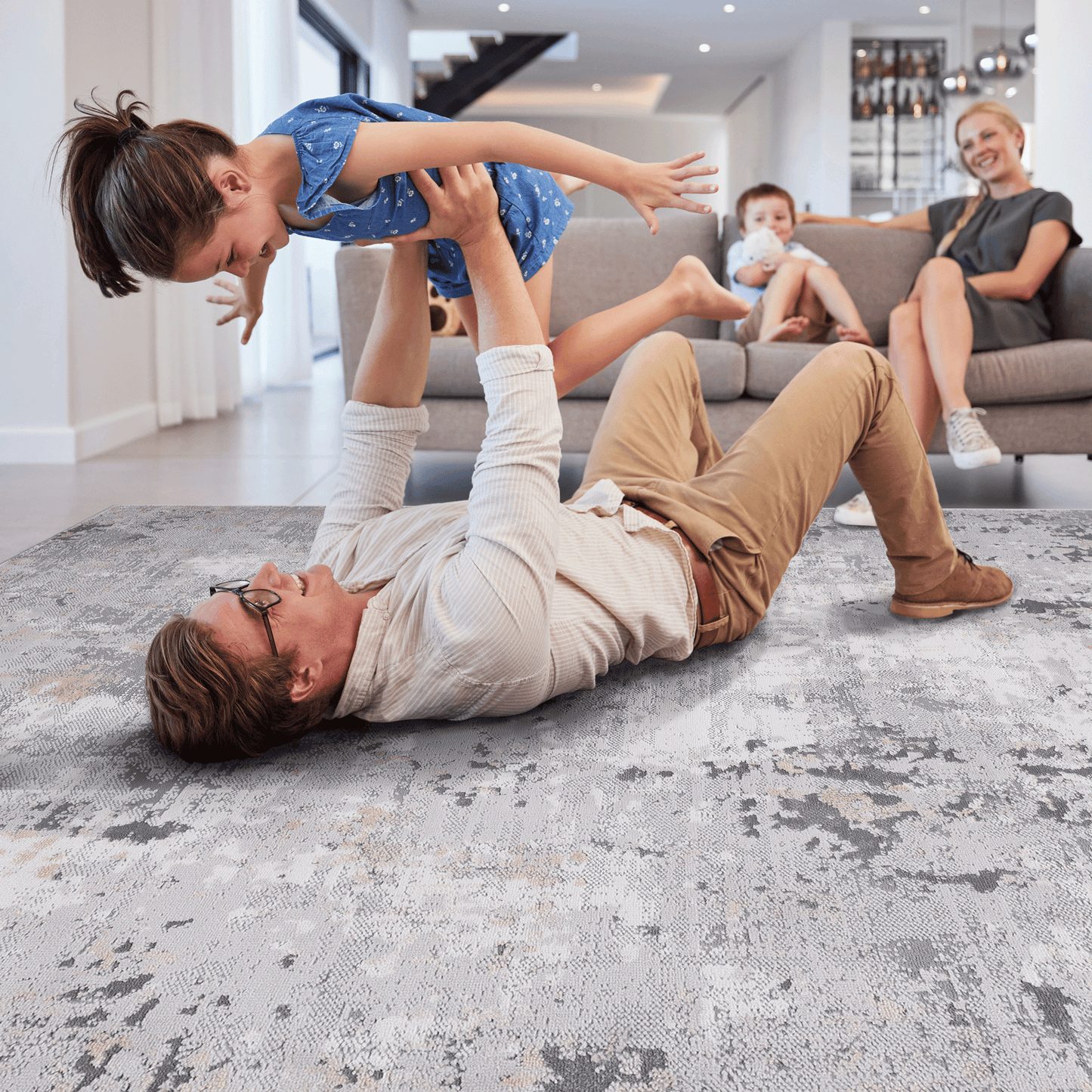 Abstract gray and cream textured area rug with distressed pattern