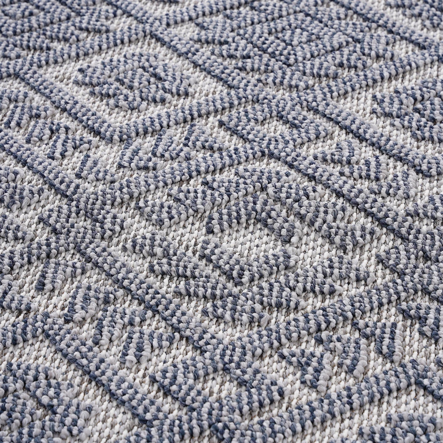 Textured diamond pattern area rug in navy blue and white for living room