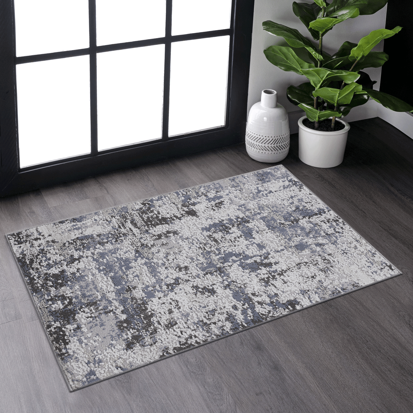Abstract pattern area rug with grey white and blue tones soft texture
