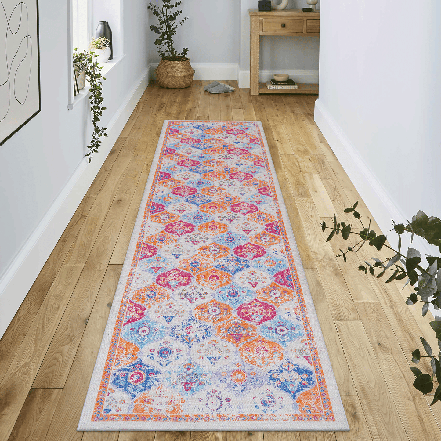 Abstract medallion hallway runner rug with vibrant orange blue and pink hues