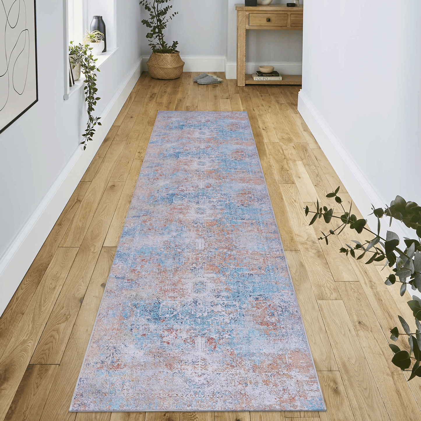 Distressed traditional runner rug in shades of blue orange and grey adds vintage charm to hallway floors