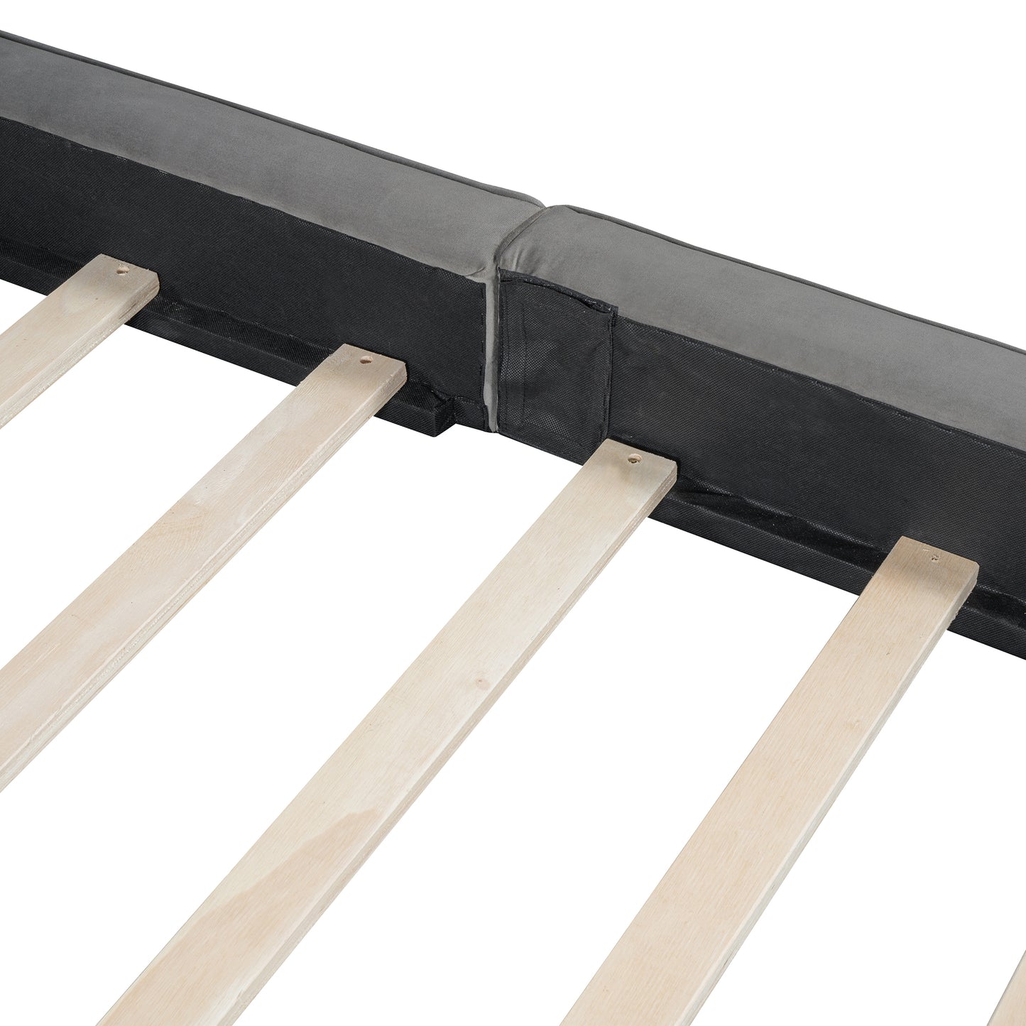 Closeup of a grey upholstered bed frame with wooden slats