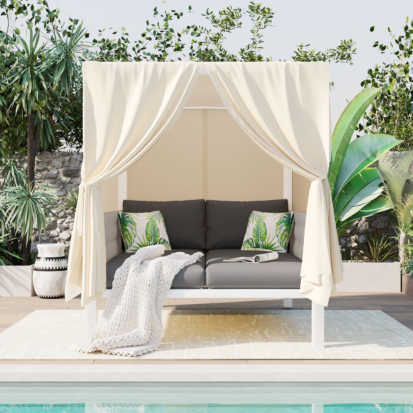 Elegant outdoor cabana with cream curtains charcoal sofa and tropical pillows perfect for poolside relaxation