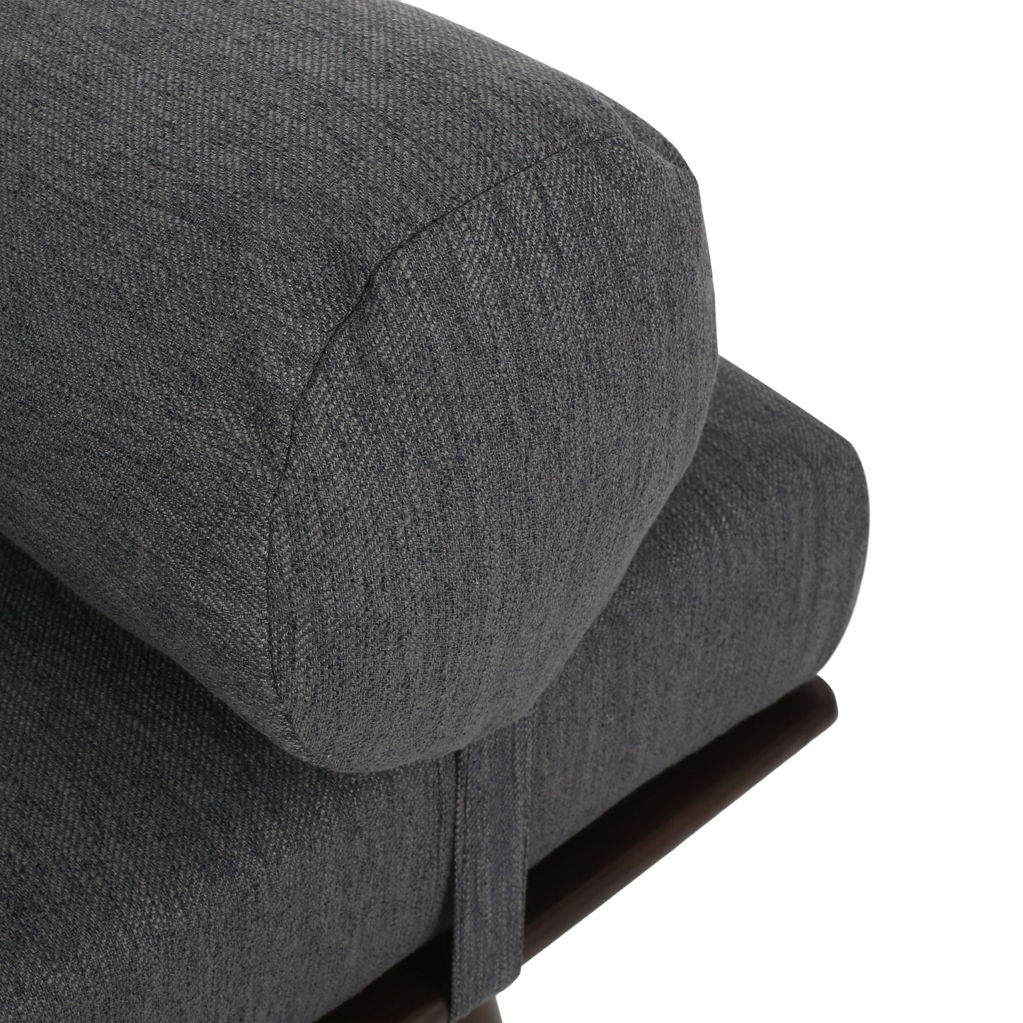 Closeup of charcoal grey textured fabric bolster on modern sofa