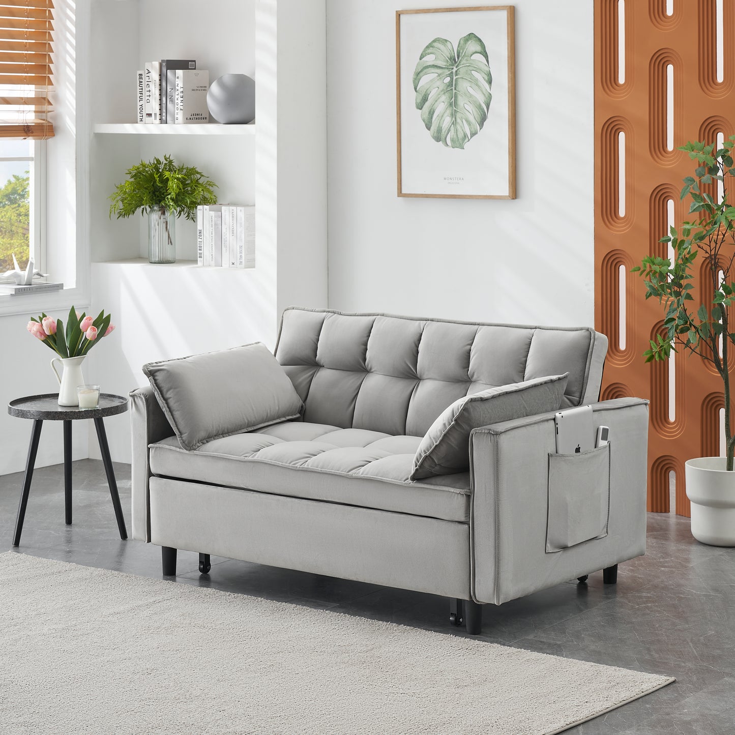 Modern gray velvet sofa with tufted cushions and convenient side pocket for storage