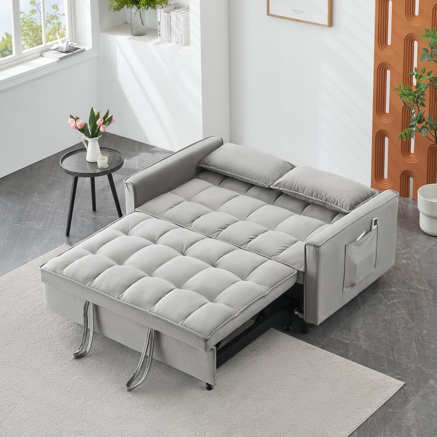 Gray velvet sleeper sofa with tufted cushions and side pocket storage