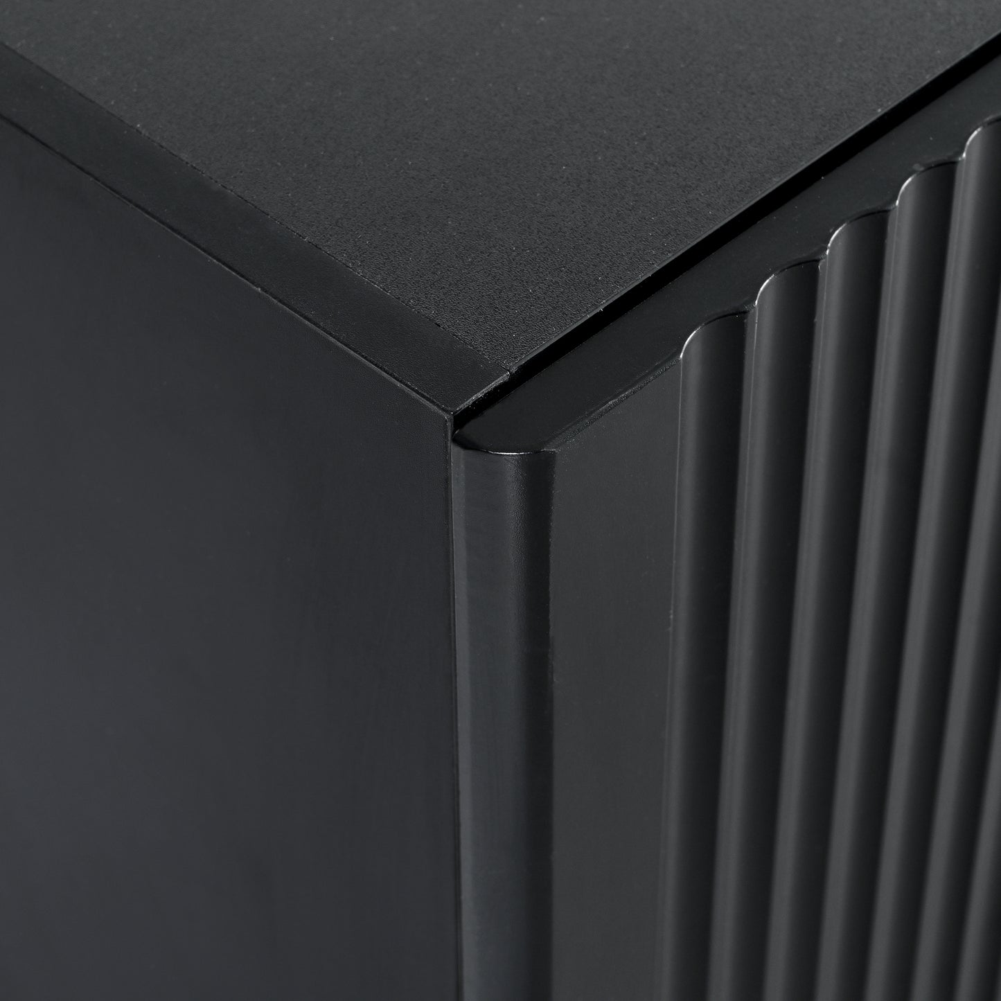 Dark grey ribbed cabinet corner featuring fluted side panel detail