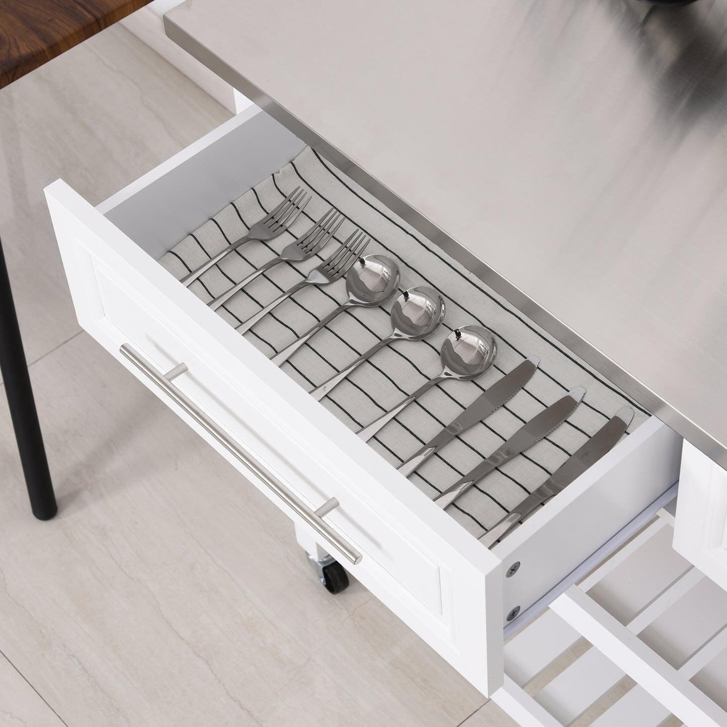 Stainless steel ladle and soup spoons neatly arranged in a drawer