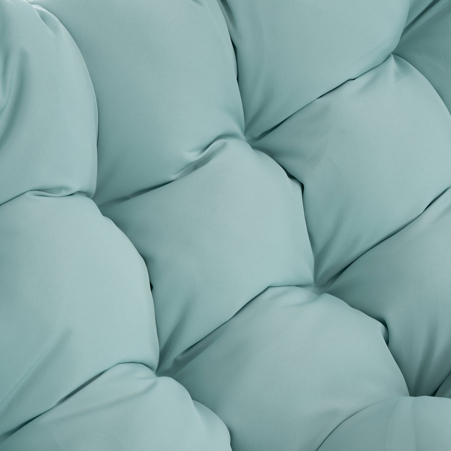 Closeup of plush light blue fabric with diamond tufting detail on a comfortable cushion