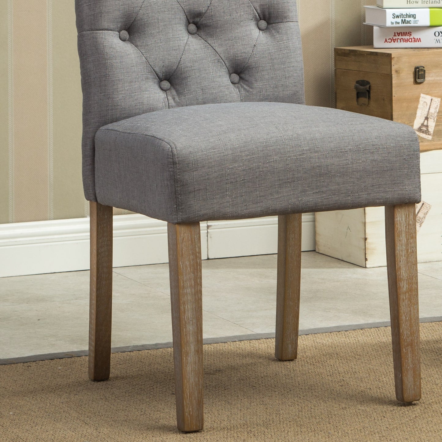 Grey linen upholstered dining chair with tufted back and wooden legs