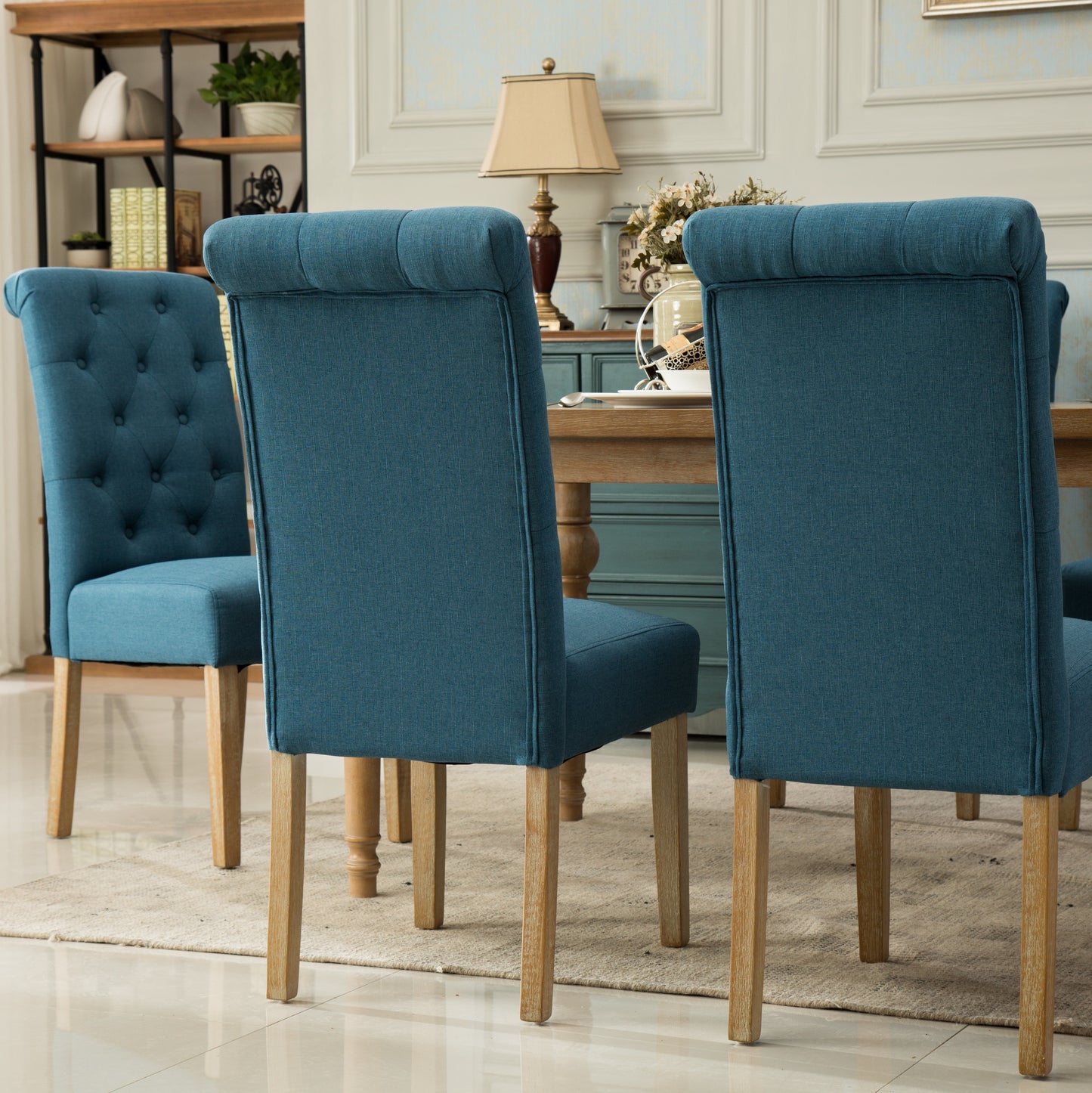 Tufted back dining chair in deep teal linen with wooden legs