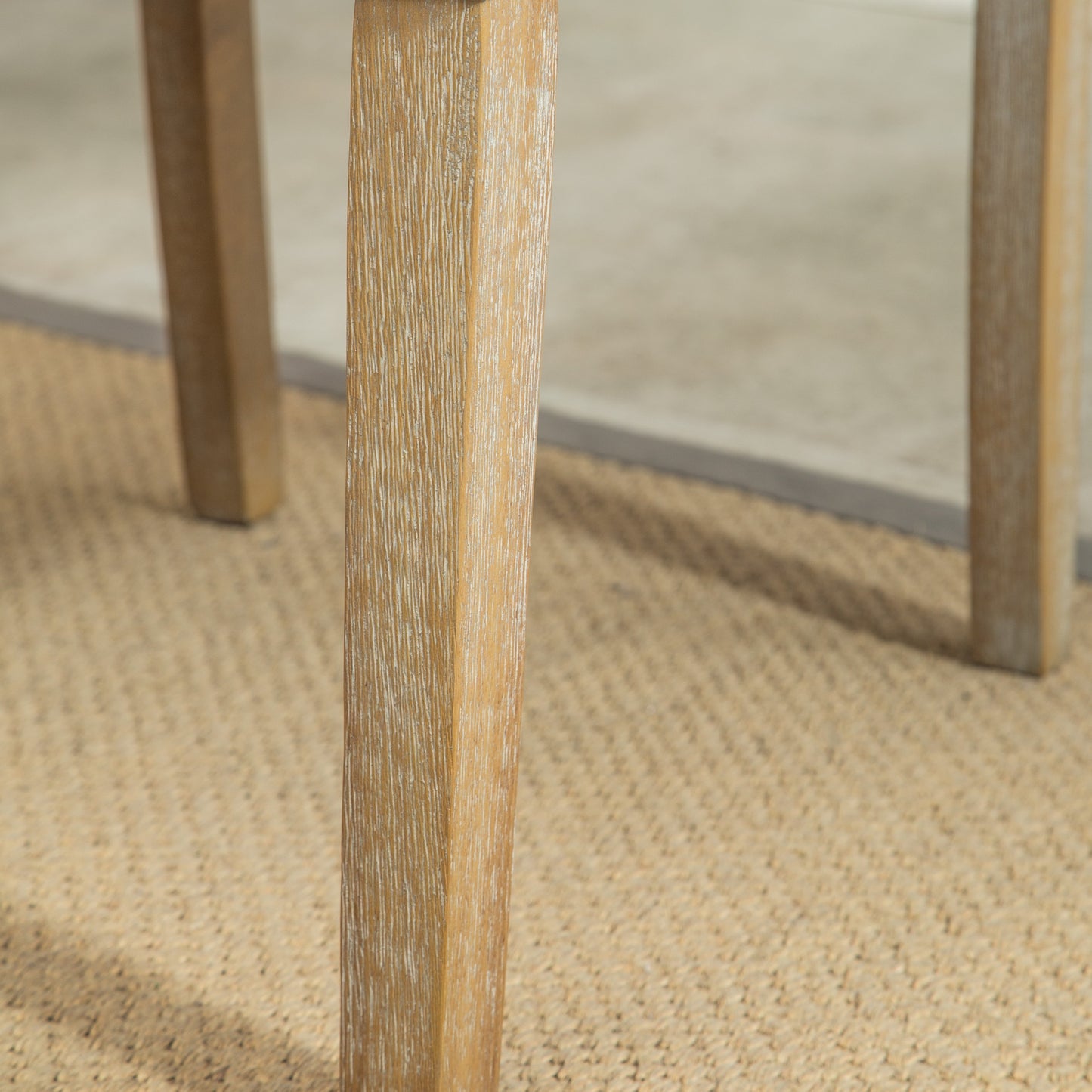 Closeup of a light oak wood table leg with a distressed finish perfect for rustic dining rooms