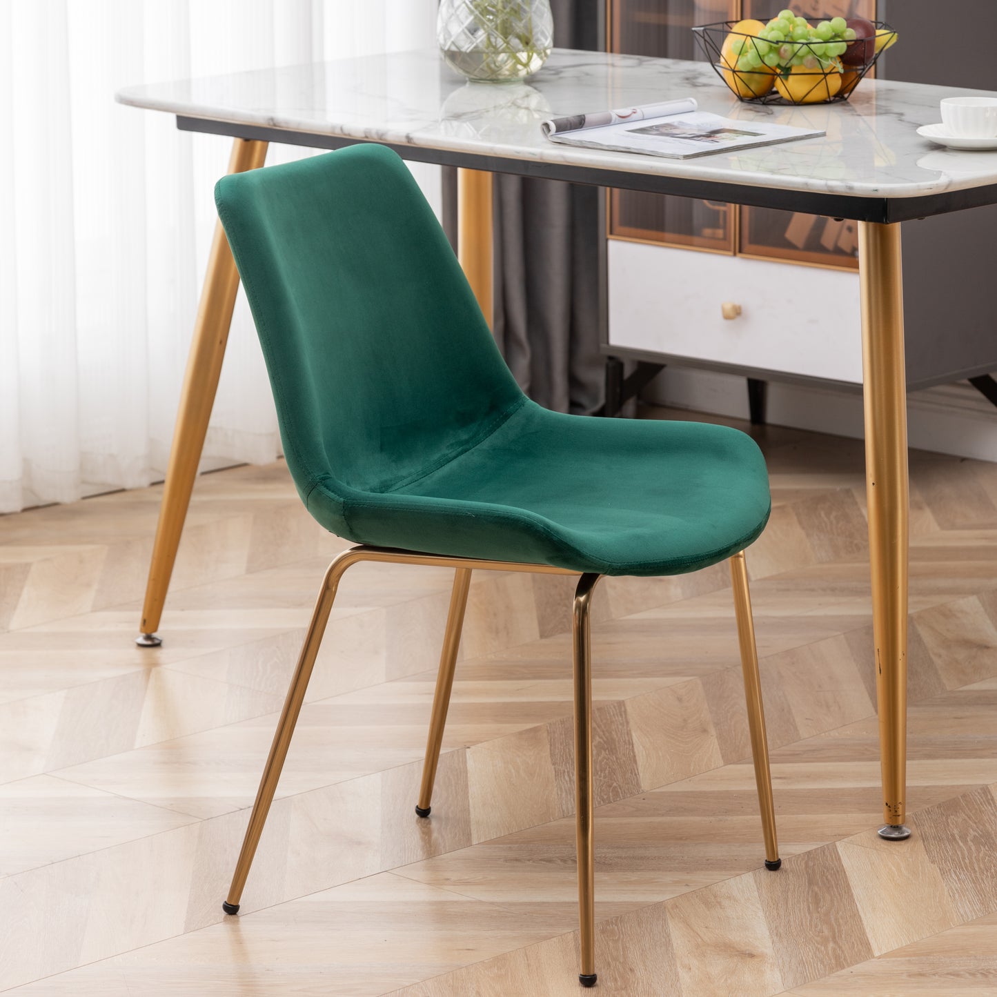 Emerald green velvet accent chair with sleek gold metal legs