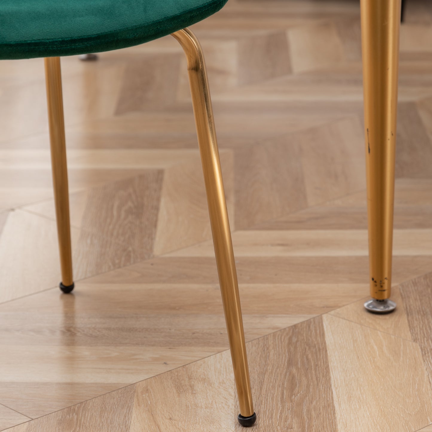 Emerald green velvet chair seat detail with gold metal legs