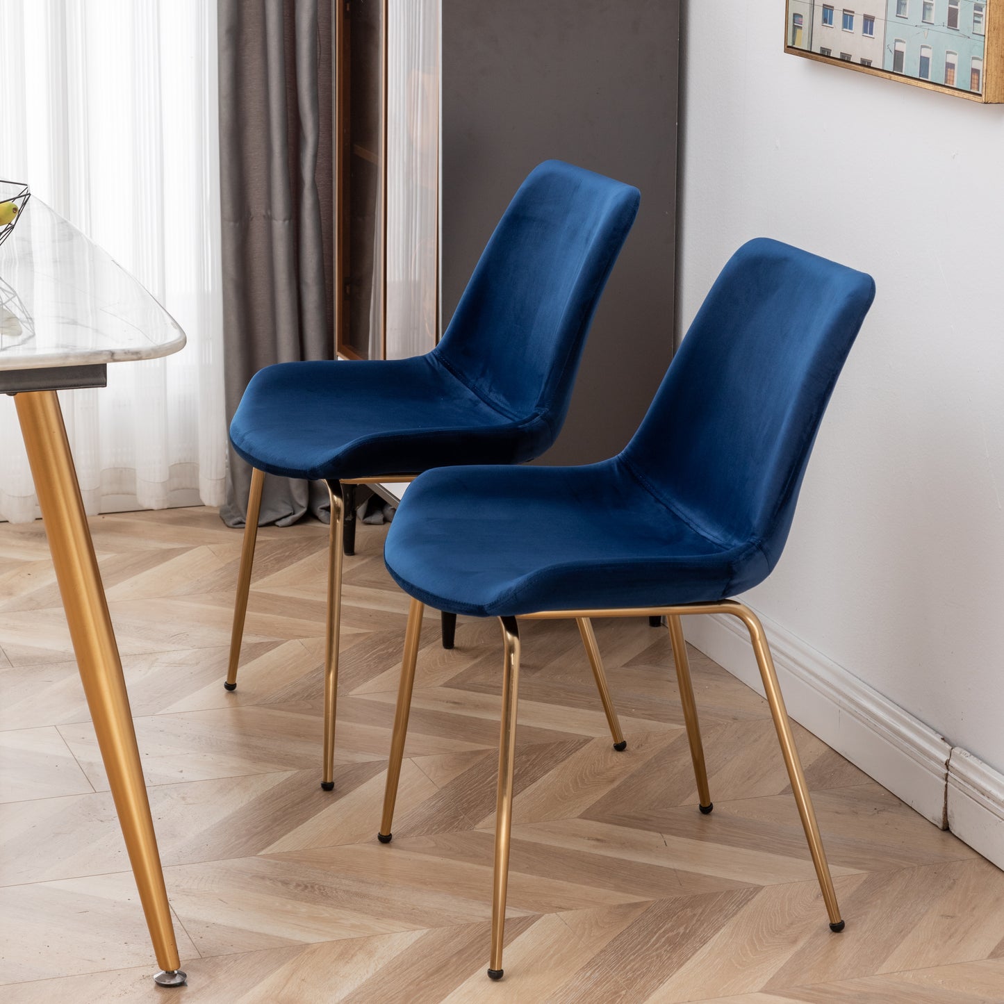 Plush navy blue velvet dining chair with sleek gold legs
