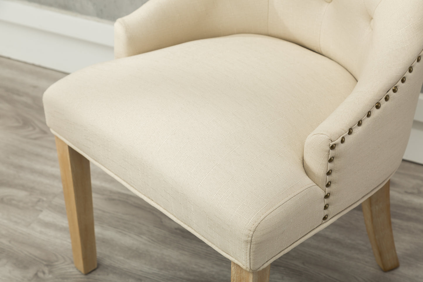 Cream linen upholstered accent chair with nailhead trim detail