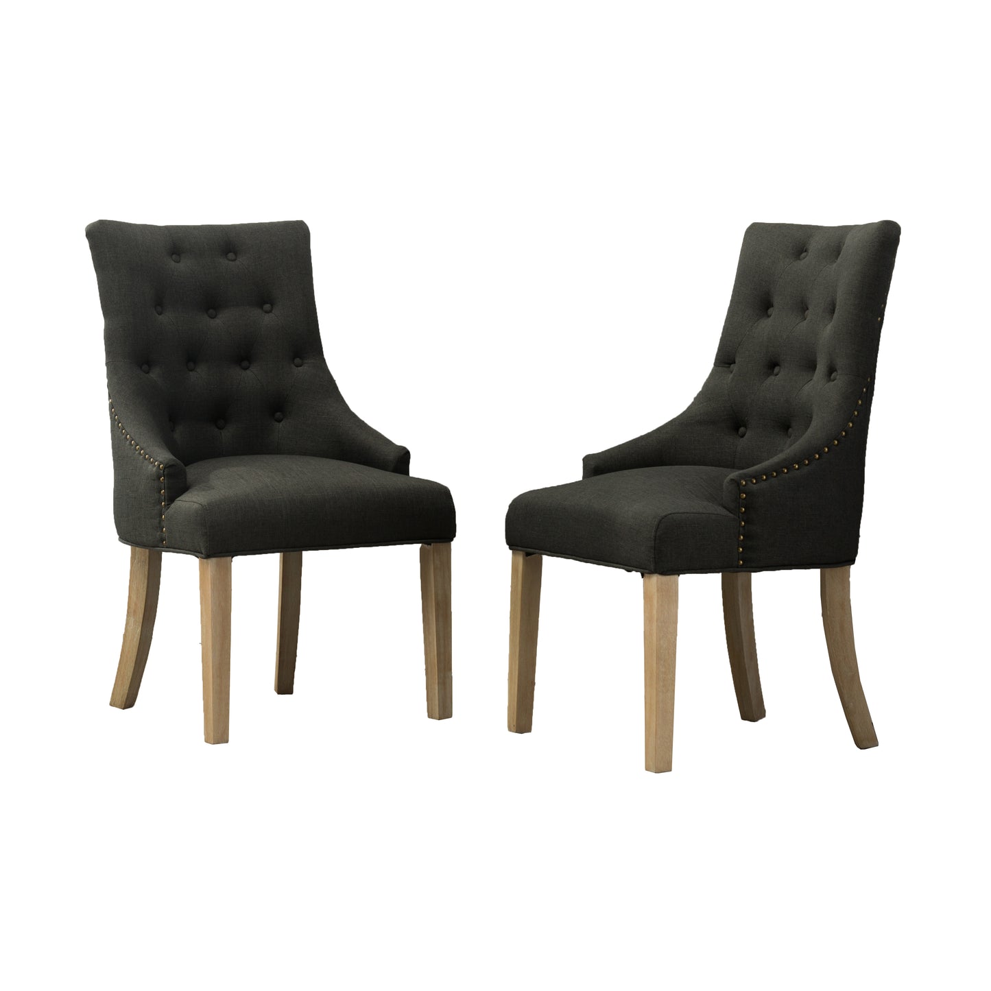 Two dark grey tufted dining chairs with brass nailhead trim and wooden legs