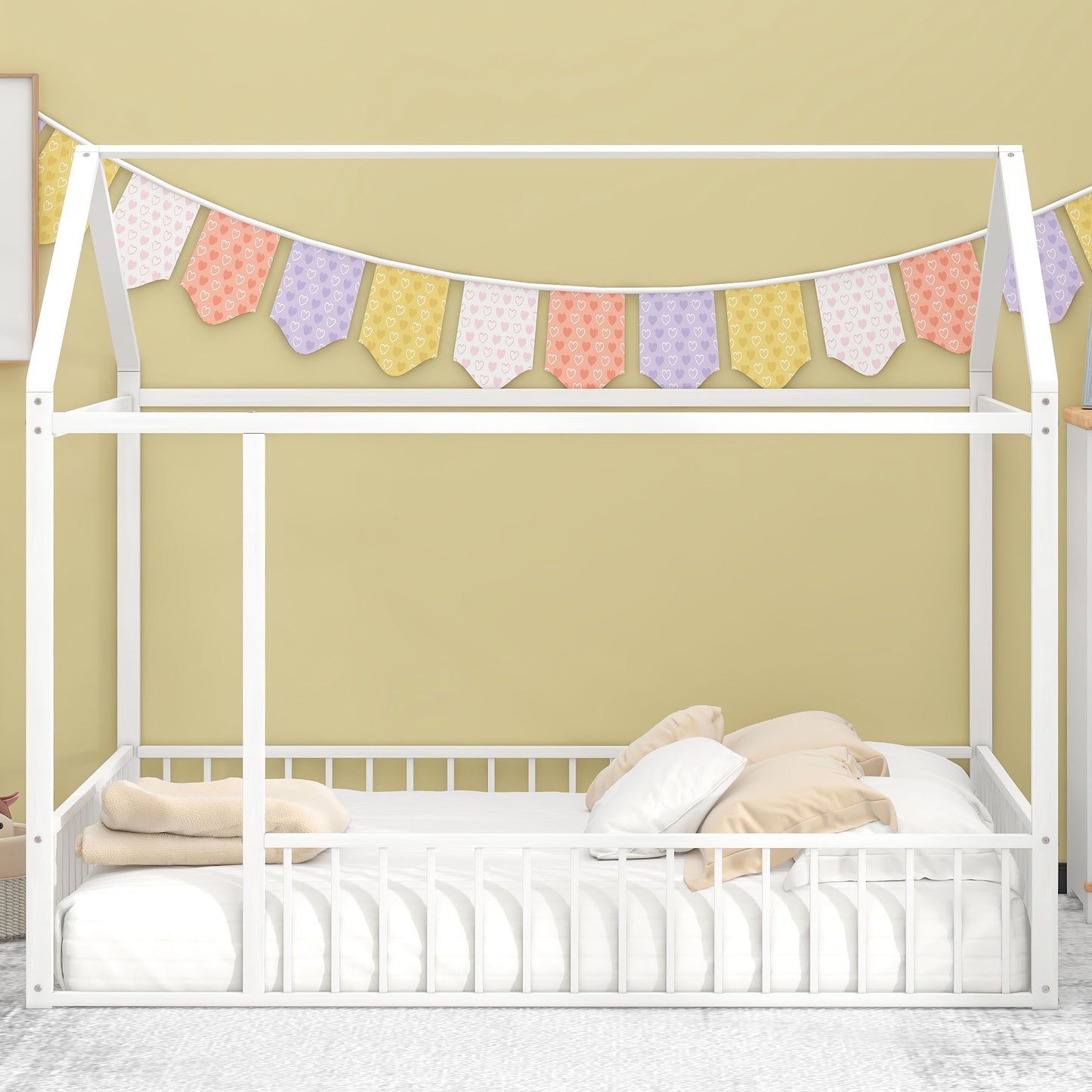 White wooden house bed frame with colorful heart garland