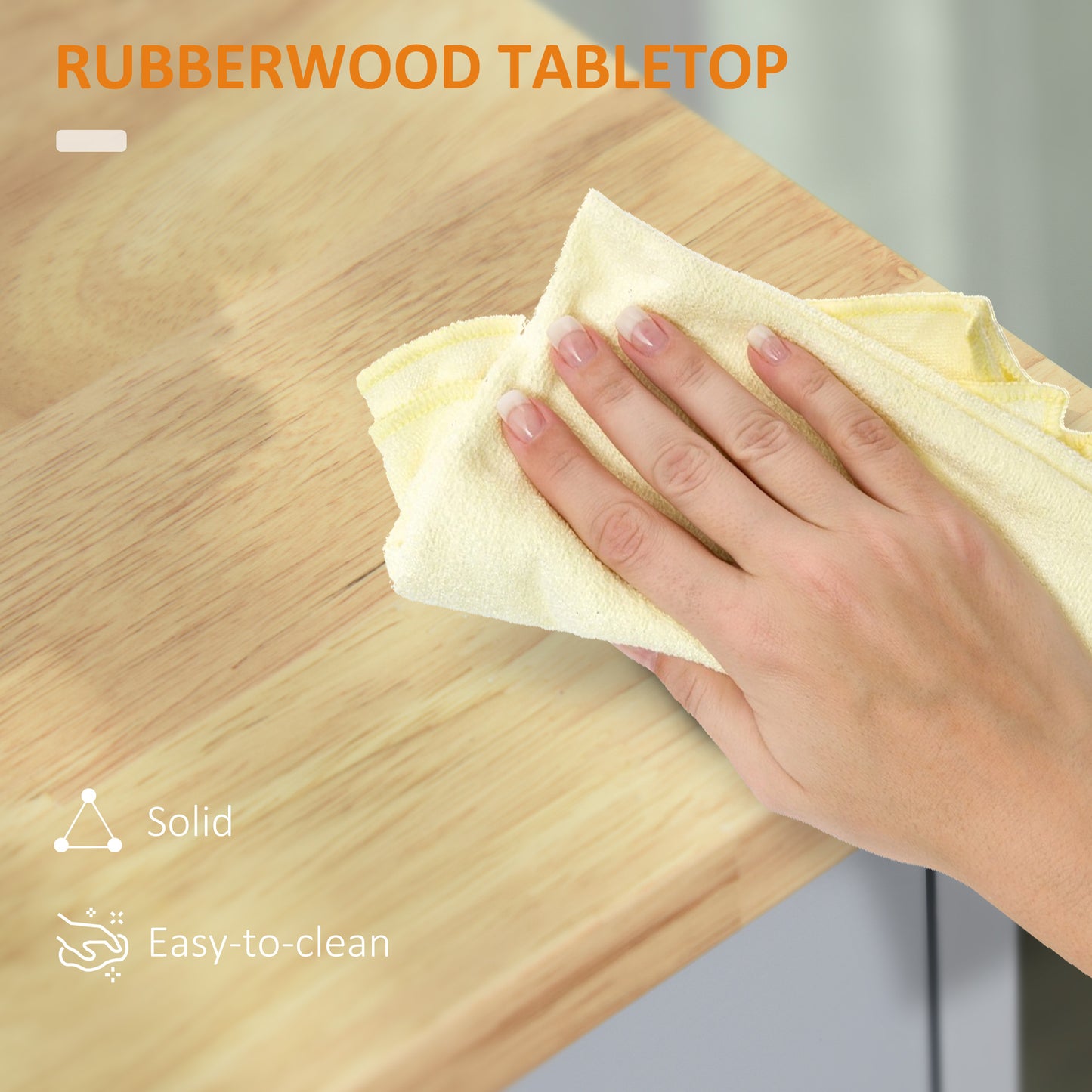 Closeup of a hand wiping a natural wood rubberwood tabletop with a yellow cloth