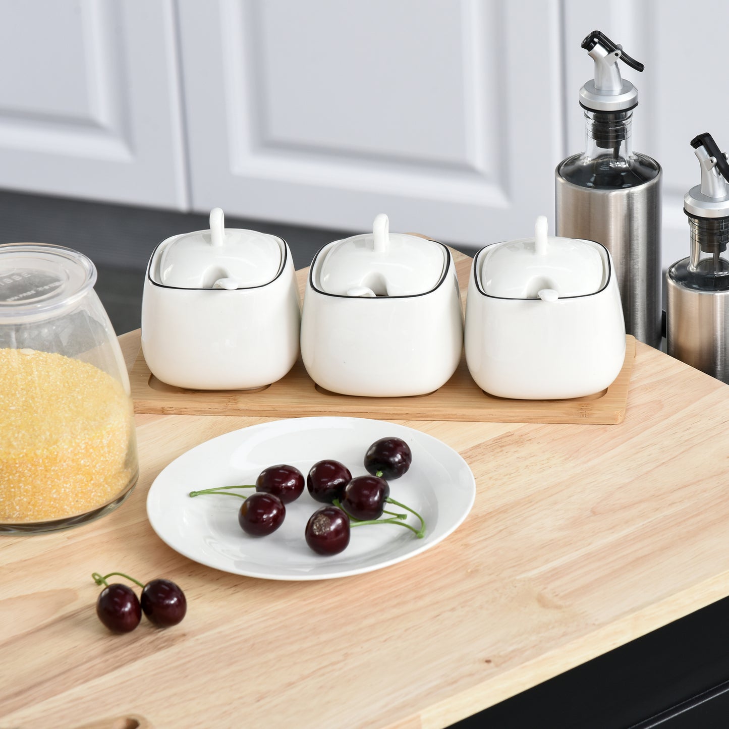 Set of white ceramic sugar bowls with black trim and lids