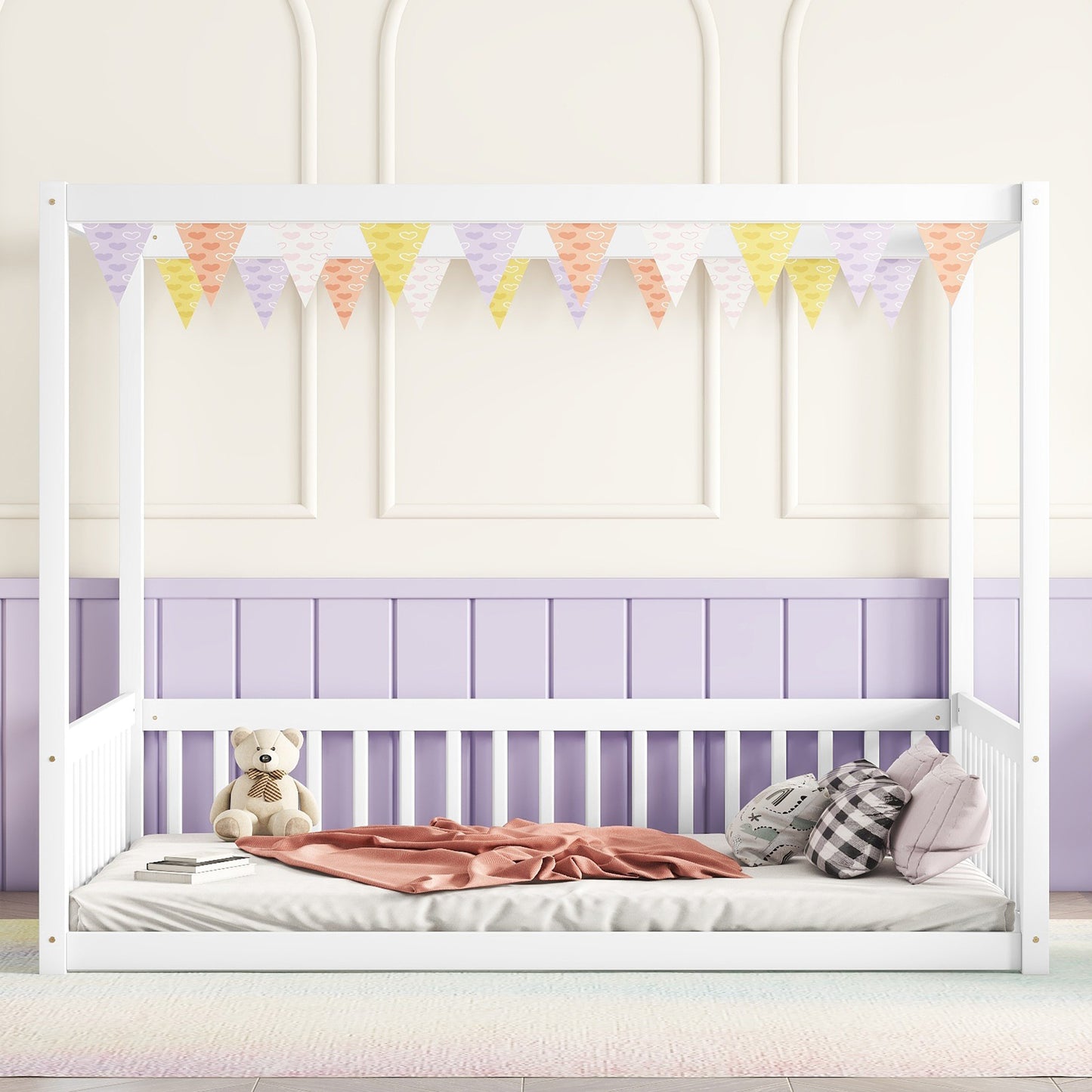 White wooden canopy bed frame with pastel heart bunting