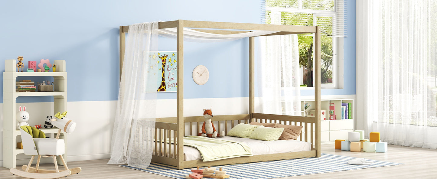 Natural wood fourposter toddler bed with sheer canopy and bedding